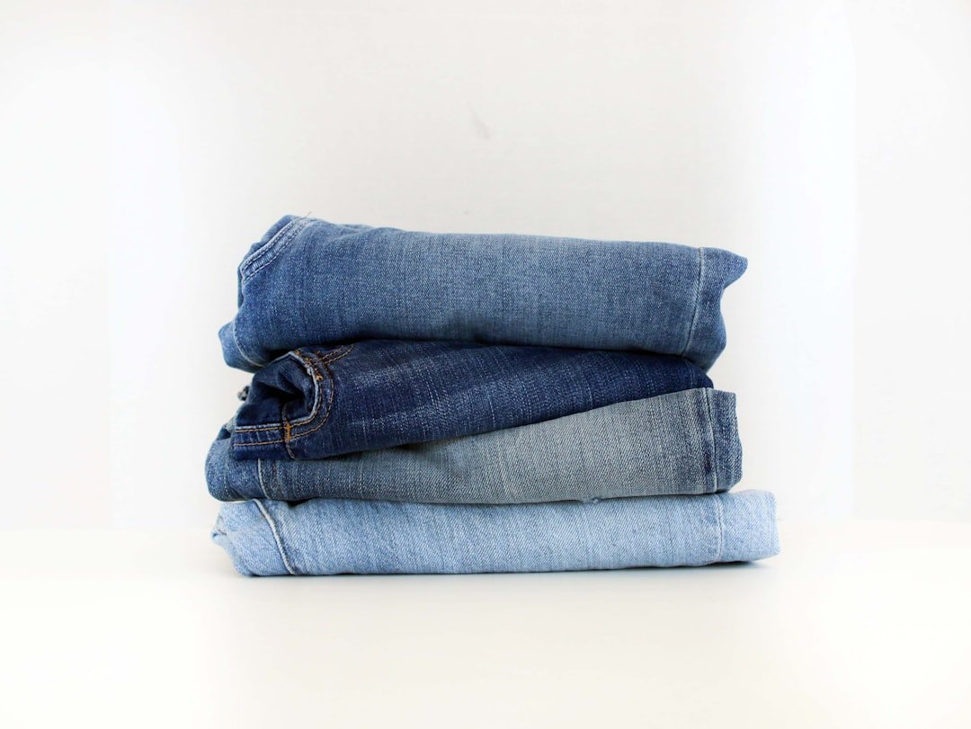 a-stack-of-jeans-sitting-on-top-of-each-other-awltxw6kbdw